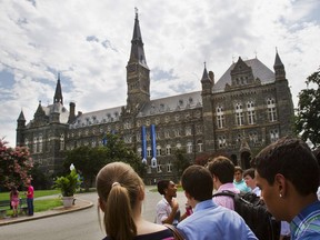 FILE - Prospective students tour Georgetown University's campus, on July 10, 2013, in Washington. Amin Khoury is scheduled to stand trial Tuesday June 7, 2022, in Boston, on charges that he bribed Georgetown University tennis coach Gordon Ernst to get his daughter into the school as a recruit.
