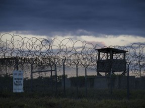 FILE - In this photo reviewed by U.S. military officials, the sun sets behind the closed Camp X-Ray detention facility, Wednesday, April 17, 2019, in Guantanamo Bay Naval Base, Cuba. An Afghan prisoner held in U.S. custody for nearly 15 years has finally been released from the Guantanamo Bay detention center, the Taliban in Afghanistan and an international human rights group said Friday, June 24, 2022.