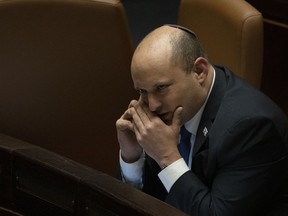 FILE - Israeli Prime Minister Naftali Bennett makes a call before voting on a law on the legal status of Jewish settlers in the occupied West Bank, during a session of the Knesset, Israel's parliament, in Jerusalem, June 6, 2022. Nir Orbach, a member of Israeli Prime Minister Naftali Bennett's party, said Monday, June 13, 2022, he would cease voting with the governing coalition, dealing yet another blow to the teetering government as it marks one year in office.