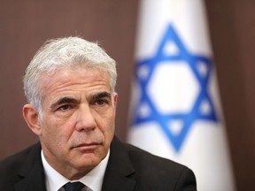 FILE - Israeli Foreign Minister Yair attends a cabinet meeting at the prime minister's office in Jerusalem, May 15, 2022. Lapid said Wednesday, June 15, 2022, that Israel is looking to U.S. President Joe Biden's Mideast trip next month to help normalize relations with Saudi Arabia, a country with which it does not have official ties. Lapid spoke a day after the White House announced the whirlwind trip to Israel and the West Bank followed by a flight to Saudi Arabia.