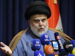 FILE - Populist Shiite cleric Muqtada al-Sadr, speaks during a mews conference in Najaf, Iraq, Nov. 18, 2021. Iraq's Parliament is set to hold a session Thursday, June 23, 2022, to vote in replacements for 73 lawmakers who resigned earlier this month. The collective walkout by followers of al-Sadr, Iraq's most influential Shiite politician, threw Iraq into further uncertainty, deepening a months-long political crisis over government formation.