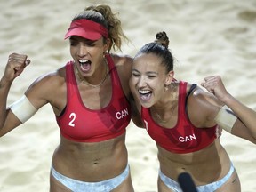 Canada's Brandie Wilkerson, left, and Canada's Sophie Bukovec celebrate after winning the beach volley semifinal match against Germany's Mueller-Tillmann at the beach volley World Championships in Rome, Saturday, June 18, 2022.