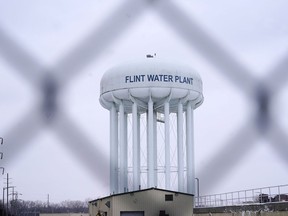FILE - The Flint water plant tower is seen, Thursday, Jan. 6, 2022, in Flint, Mich. The Michigan Supreme Court has ruled that charges related to the Flint water scandal against former Gov. Rick Snyder, his health director and seven other people must be dismissed. The justices found Tuesday, June 28, 2022 that the judge had no authority to issue the indictments. It's an astonishing defeat for Attorney General Dana Nessel.