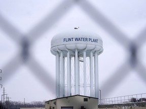 FILE - The Flint water plant tower is seen, Thursday, Jan. 6, 2022, in Flint, Mich. A Michigan Supreme Court order that charges related to the Flint water scandal against former Gov. Rick Snyder, his health director and seven other people must be dismissed is the latest development in the crisis that started in 2014. That was when the city began taking water from the Flint River without treating it properly, resulting in lead contamination.