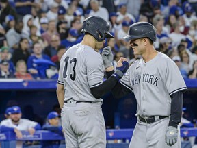 New York Yankees first baseman Anthony Rizzo (right) and left-fielder Joey Gallo (13) celebrate after Rizzo hit a grand slam during fifth inning MLB baseball action against the Toronto Blue Jays, in Toronto on Friday, June 17, 2022.