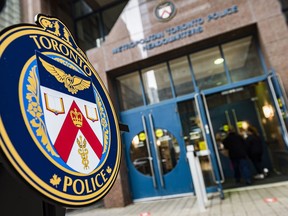 The Toronto Police Services emblem is photographed during a press conference at TPS headquarters, in Toronto on Tuesday, May 17, 2022. Toronto police say a 33-year-old man has been charged after allegedly setting a woman on fire on a city bus on Friday in what is now being investigated as a suspected hate crime.