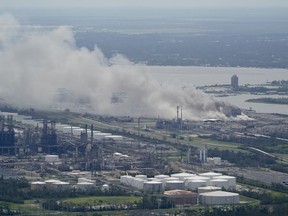 FILE - A chemical fire burns at a facility during the aftermath of Hurricane Laura, Aug. 27, 2020, near Lake Charles, La. The Securities and Exchange Commission moved closer Friday, June 17, 2022, to a final rule that would dramatically change what public companies tell shareholders about climate change. Companies would also have to disclose risks related to the physical impact of storms, drought and higher temperatures brought on by global warming.