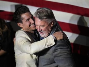 Joe O'Dea, right, Republican nominee to run for the U.S. Senate seat held by Democrat Michael Bennet, is hugged by his son-in-law David Freund on the stage before speaking at a primary election night watch party, Tuesday, June 28, 2022, in Denver.