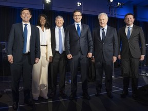 Candidates Patrick Brown, left, Leslyn Lewis, Scott Aitchison, Pierre Poilievre, Jean Charest and Roman Baber, pose for photos after the French-language Conservative Leadership debate Wednesday, May 25, 2022, in Laval, Que.