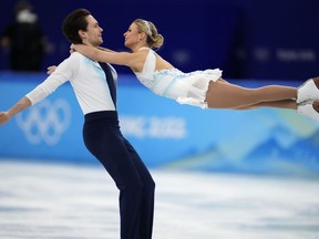 Kirsten Moore-Towers and Michael Marinaro, of Canada, compete in the pairs free skate program during the figure skating competition at the 2022 Winter Olympics, Saturday, Feb. 19, 2022, in Beijing.&ampnbsp;Kirsten Moore-Towers and Michael Marinaro, who teamed up for three Canadian pairs titles, have retired from competitive figure skating.