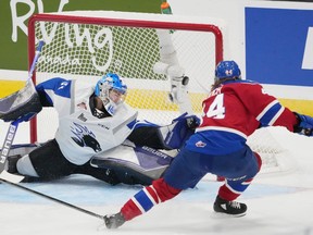 Edmonton Oil Kings' Carter Souch, right, scores over Saint John Sea Dogs goaltender Nikolas Hurtubise during the first period of Memorial Cup hockey action in Saint John, N.B. on Wednesday, June 22, 2022.