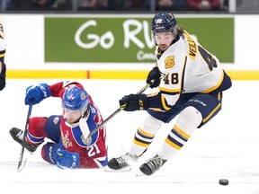 Edmonton Oil Kings' Jake Neighbours, left, loses an edge while fighting for the puck with Shawinigan Cataractes' William Veillette during the third period of Memorial Cup hockey action in Saint John, N.B. on Tuesday, June 21, 2022.