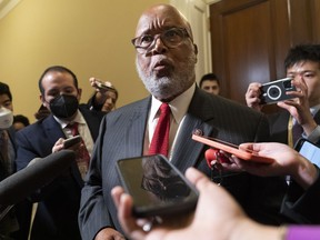 Chairman of the House select committee investigating the Jan. 6, 2021, attack on the Capitol, Rep. Bennie Thompson, D-Miss., is reflected in a cell phone as he talks with the media after a hearing of the committee, Thursday, June 16, 2022, on Capitol Hill in Washington.