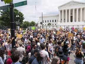 Protesters gather outside the Supreme Court in Washington, Friday, June 24, 2022. The Supreme Court has ended constitutional protections for abortion that had been in place nearly 50 years, a decision by its conservative majority to overturn the court's landmark abortion cases.