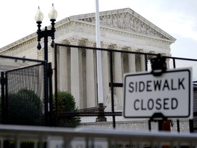 Security fencing surrounds the U.S. Supreme Court building, Monday, June 27, 2022, in Washington.
