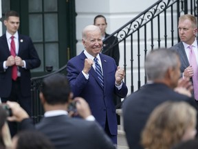 President Joe Biden cheers on rider at the White House in Washington, Thursday, June 23, 2022, during an event to welcome wounded warriors, their caregivers and families to the White House as part of the annual Soldier Ride to recognize the service, sacrifice, and recovery journey for wounded, ill, and injured service members and veterans.