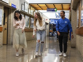 Students Isabel Wei, Kirsten Krochak and Paul Lifotra (left to right) walk the halls at Harry Ainlay High School in Edmonton on Wednesday, June 15, 2022.