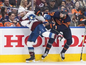 Colorado Avalanche's Devon Toews (7) is checked by Edmonton Oilers' Leon Draisaitl (29) during second period NHL conference finals action in Edmonton on Monday, June 6, 2022. New research concludes that allowing young hockey players to bodycheck at an early age doesn't protect them from injury as they move into older, harder-hitting leagues.THE CANADIAN PRESS/Jason Franson