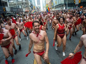People march in the Pride parade in downtown Toronto, marking the return of in-person festivities for the annual LGBTQ celebration, in Toronto, June 26, 2022.