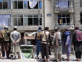 Taliban fighters gather at the site of an explosion in front of a Sikh temple in Kabul, Afghanistan, Saturday, June 18, 2022. Several explosions and gunfire ripped through a Sikh temple in Afghanistan's capital.