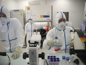 FILE - Laboratory technicians work at the Valneva headquarters in Saint-Herblain, western France, on Feb.3, 2021. The European Medicines Agency said it is recommending the authorization of the coronavirus vaccine made by French pharmaceutical Valneva, making it the sixth shot given the green light in Europe.