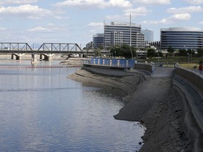 FILE - The slow process of refilling Tempe Town Lake takes place after a new dam was built to replace the previously damaged dam, on April 12, 2016, in Tempe, Ariz. The Phoenix suburb is reviewing how to handle water rescues as video of three police officers appearing to do nothing as a homeless man drowns continues to draw outcry. The Tempe Police Department says the three officers are on administrative paid leave after last month's drowning in the man-made city lake.