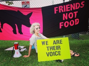 Regan Russell is shown protesting outside Fearmans Pork in Burlington, Ont., in this undated handout photo. On Father's Day, Mark Powell donated a bench to honour his late wife, Regan Russell, at an animal sanctuary north of Toronto.