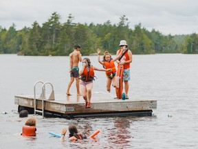 Children jump into the lake at Brigadoon Village, a summer camp for children with chronic health conditions that has also been offering programs for children who are grieving, in a 2021 handout photo. The centre in Aylesford, N.S., announced on Saturday that it has completed a $12.5-million expansion project that will give it capacity for more than 300 added campers this summer.