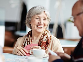 Senior people playing cards in caf