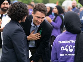 Prime Minister Justin Trudeau thanks Maryam Al-Sabbawi following her speech during a ceremony and march in memory of the Afzaal family in London, Ont. on Sunday June 5, 2022. The march Sunday is to honour the Muslim family mowed down one year ago by a pickup truck driver while they took an evening walk.