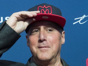 Gary Stern the new co-owner of the Montreal Alouettes tries on a cap following a news conference in Montreal, Monday, January 6, 2020.