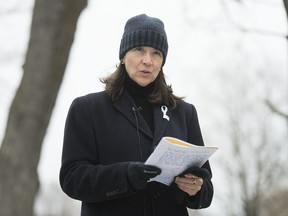 Nathalie Provost, a survivor of the École polytechnique shooting in 1989, reads a poem during an event in Montreal, Sunday, Dec. 6, 2020, on the 31st anniversary of the murder of 14 women in an anti-feminist attack at the university on Dec. 6, 1989.