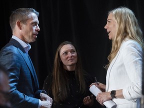 Minister of Sport Pascale St-Onge, right, talks with Olympic athlete Rosie MacLennan and COC CEO David Shoemaker speak following a news conference in Montreal, Sunday, June 12, 2022.