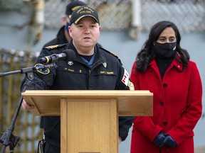 Cmdr. Dale St. Croix, commanding officer of HMCS Halifax delivers remarks as Defence Minister Anita Anand, right, look on as the frigate prepares to depart Halifax in support of NATO's deterrence measures in eastern Europe on Saturday, March 19, 2022.