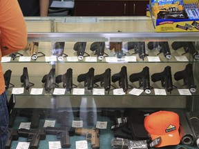 Handguns are on displayed at a gun shop, Thursday, June, 23, 2022 in Honolulu.