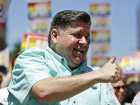 Illinois Gov. JB Pritzker gives a thumbs-up to the crowd during the 51st Chicago Pride Parade in Chicago, Sunday, June 26, 2022.
