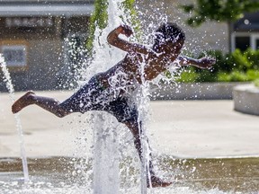 Damian Stewart, 8, plays in the splash pad at Howard Park, Tuesday, June 14, 2022, in downtown South Bend, Ind.