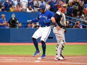 Toronto Blue Jays' centre fielder George Springer crosses the plate after an RBI double by teammate Bo Bichette, not shown, in first inning American League baseball action against the Boston Red Sox, in Toronto on Monday June 27, 2022.