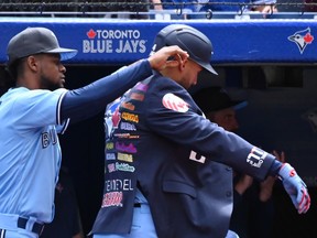 Toronto Blue Jays' centre-fielder George Springer, right, receives the home run jacket from Otto Lopez, left, after hitting a solo home run against the New York Yankees batter in fifth inning American League baseball action in Toronto on Sunday, June 19, 2022.