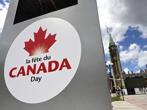 A signboard with information for upcoming Canada Day celebrations on Parliament Hill is seen in front of Centre Block's Peace Tower in Ottawa on Friday, June 17, 2022.