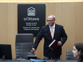 Justice William Hourigan, Commissioner of the Ottawa Light Rail Transit Commission, takes his seat before the start of the first day of proceedings at the inquiry into the troubled LRT system, in Ottawa, on Monday, June 13, 2022.