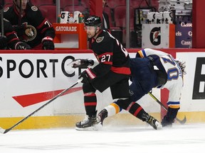 Ottawa Senators centre Dylan Gambrell (27) crashes into St. Louis Blues centre Oskar Sundqvist (70) during third period NHL hockey action in Ottawa, on Tuesday, Feb. 15, 2022. The Senators have signed Gambrell to a one-year contract extension worth US$950,000.