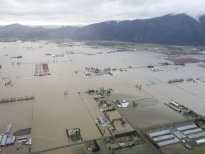 Floodwaters are seen from the air in Abbotsford, B.C., on Nov. 23, 2021. November's floods in British Columbia that swamped homes and farms, swept away roads and bridges and killed five people are now the mostly costly weather event in provincial history.