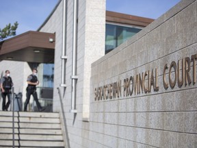 Deputy sheriffs walk into the Saskatchewan Provincial Courthouse in Prince Albert, Sask., Thursday, May 13, 2021. A former Saskatchewan Mountie has been ordered to stand trial in the killing of a 26-year-old man. Bernie Herman, who is 54, is charged with first-degree murder in the death of Braden Herman.