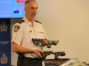 Winnipeg Police Insp. Max Waddell shows off a prohibited AR-15 rifle lower end receiver manufactured from a 3-D printer (lower) and an authentic AR-15 lower end receiver at a press conference at Winnipeg Police headquarters on Tuesday, June 9. 2020.