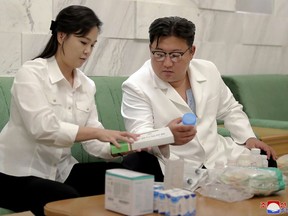 In this photo provided by the North Korean government, North Korean leader Kim Jong Un and his wife Ri Sol Ju prepare medicines at an unannounced place in North Korea Wednesday, June 15, 2022 to send them to Haeju City where an infectious disease occurred. Independent journalists were not given access to cover the event depicted in this image distributed by the North Korean government. The content of this image is as provided and cannot be independently verified. Korean language watermark on image as provided by source reads: "KCNA" which is the abbreviation for Korean Central News Agency. (Korean Central News Agency/Korea News Service via AP)