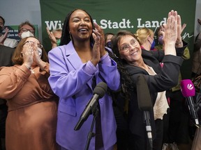 FILE - Aminata Toure, center, applauds after the first forecasts for the state election in Schleswig-Holstein were announced, in Kiel, Germany, May 8, 2022. The daughter of two Malian refugees has become the first black member of a state government in Germany. Aminata Toure was named Wednesday, June 29 to the Cabinet of Governor Daniel Guenther of Germany's northernmost state of Schleswig-Holstein, on the border with Denmark.