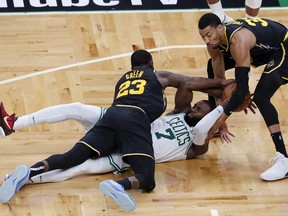 Boston Celtics guard Jaylen Brown (7) scrambles for a loose ball against Golden State Warriors forward Draymond Green (23) and forward Otto Porter Jr. (32) during the second half of Game 3 of basketball's NBA Finals, Wednesday, June 8, 2022, in Boston.
