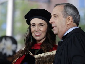 New Zealand Prime Minister Jacinda Ardern speaks with Harvard President Larry Bacow on the stage during Harvard's 371st Commencement, Thursday, May 26, 2022, in Cambridge, Mass. Ardern was the keynote speaker and received an honorary degree.