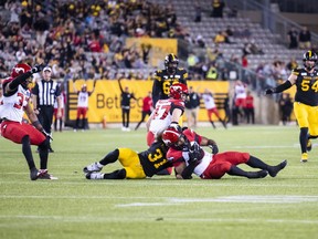 Calgary Stampeders' Jameer Thurman intercepts the ball intended for Hamilton Tiger-Cats' Sean Thomas Erlington to win the game in overtime during CFL football action in Hamilton, Ont., Saturday, June 18, 2022.